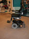 Powered wheelchair with lateral reflector