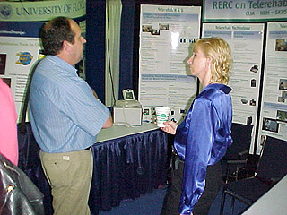 Unidentified conference attendee talks to Donal Lauderdale