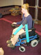 Alicia Koontz trying out a robot arm mounted on a wheelchair