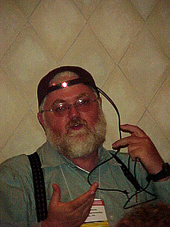 The camera flash exposes Denis Anson's reflective character